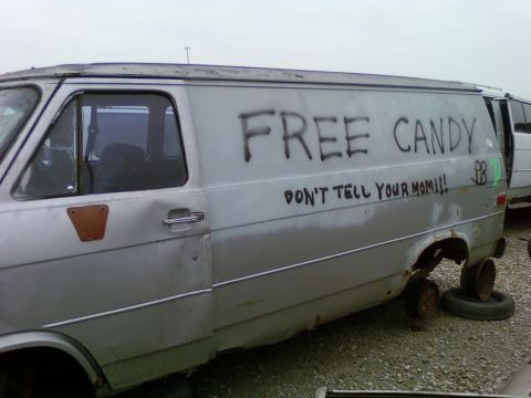 1989 Ford Bronco - This van has graffiti and is missing its wheels.