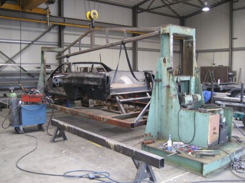 1973 Ford Ranchero - Car body mounted on a jig in a workshop, undergoing restoration or modification.