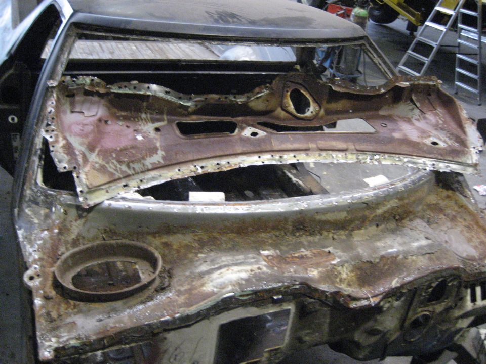 Rusted dashboard and cowl of a 1973 Ford Ranchero undergoing restoration