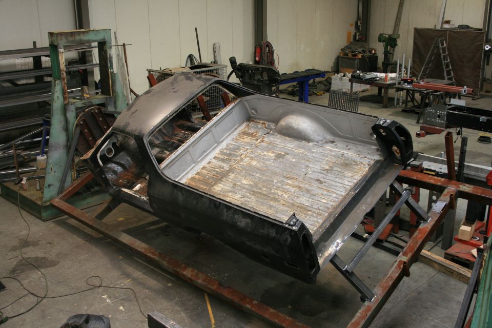 1973 Ford Ranchero body on a jig, rear view, in a workshop