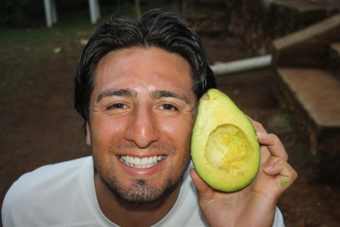 1987 Ford Bronco - A man smiles while holding a halved avocado in front of his face, with a website logo visible.