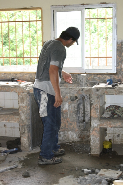 1987 Ford Bronco - Demolition of a sink area with a man overseeing the work.