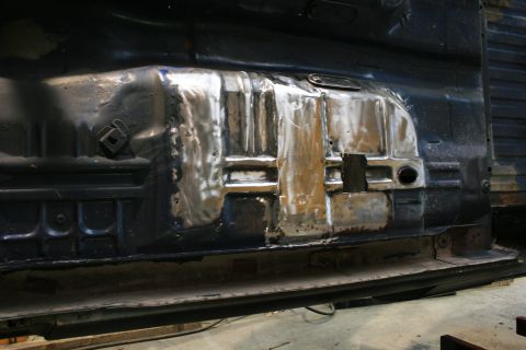 1973 Ford Ranchero - This image shows a section of a vehicle's floor pan that has undergone repair work, with visible welding and metal patches.