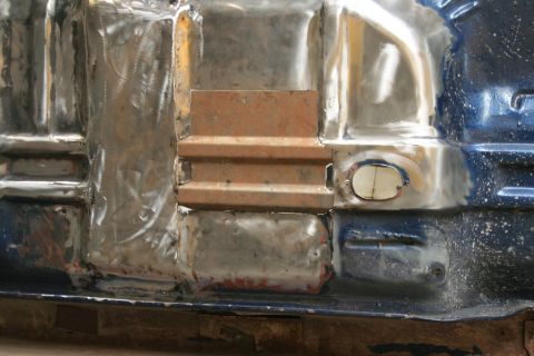 1973 Ford Ranchero - Undercarriage repair work shows welded metal patches and structural components.
