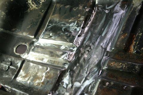 1973 Ford Ranchero - Vehicle undercarriage shows extensive metalwork and repairs to the floor pan and frame.