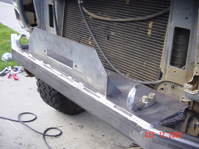 Fabricated steel front bumper tacked onto a truck frame in front of the radiator, tools on driveway, Oct 2003