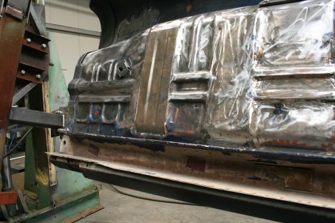 1973 Ford Ranchero - Metal body panel undergoing repair work in a workshop setting.