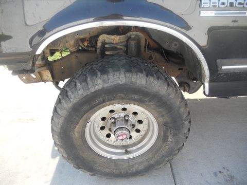 1991 Ford Bronco - Close-up of the front wheel and fender of a 1991 Ford Bronco.