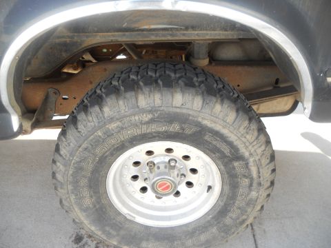 1991 Ford Bronco - Close-up of the rear wheel and suspension on a 1991 Ford Bronco.