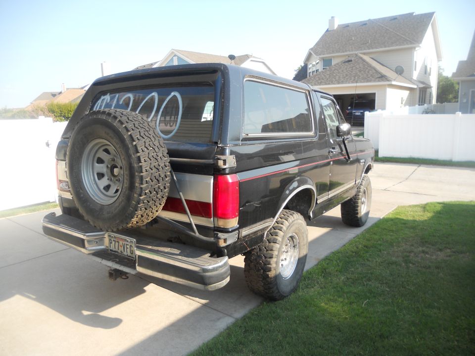Rear view of black 1991 Ford Bronco with spare tire mounted on tailgate