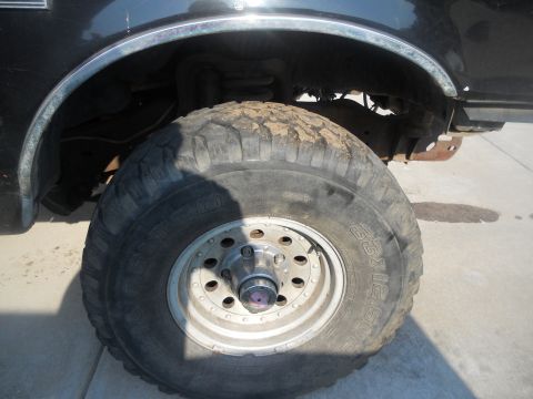 1991 Ford Bronco - Close-up of the front wheel and fender of a 1991 Ford Bronco.