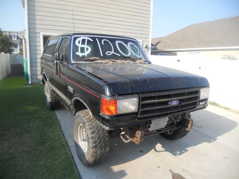 1991 Ford Bronco - This black Ford Bronco is for sale for $1200, but it's missing a front bumper and a wheel.