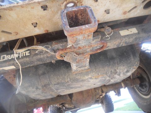1991 Ford Bronco - Undercarriage view showing a Draw-Tite hitch assembly and a large fuel tank, with visible wiring and suspension components.