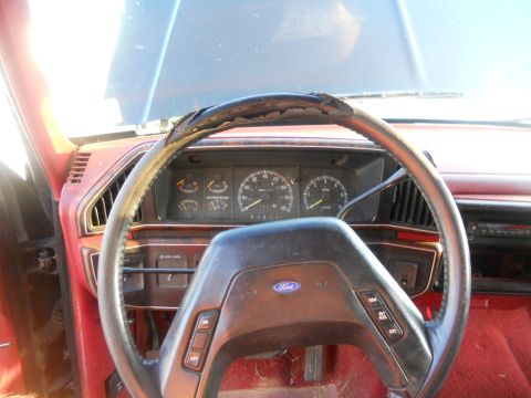 1991 Ford Bronco - Interior view of a 1991 Ford Bronco, a worn steering wheel and dashboard.