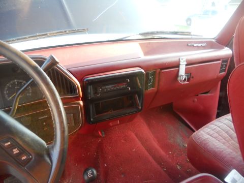 1991 Ford Bronco - The interior of a 1991 Ford Bronco features a red dashboard and carpeting, with the 'Bronco' nameplate visible.