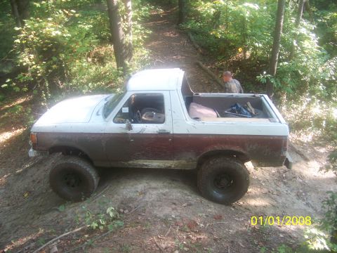 1989 Ford Bronco - This lifted 1989 Ford Bronco navigates a muddy trail during an off-road event.