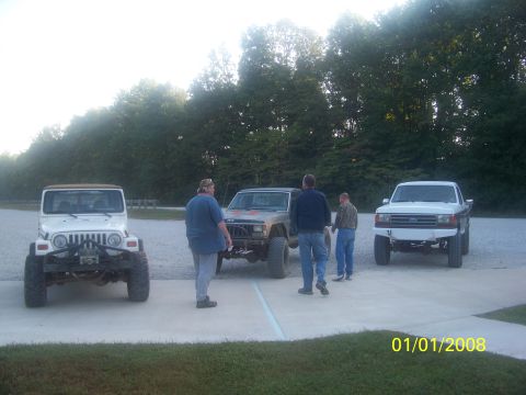 1989 Ford Bronco - A white Ford pickup truck is parked alongside two Jeeps, with three people standing nearby. The photo is dated January 1, 2008.