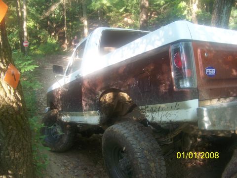 1989 Ford Bronco - This lifted Ford Bronco is navigating a muddy, wooded trail with a date stamp of 01/01/2008.