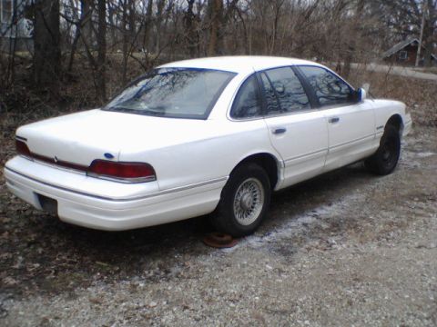1994 Ford Crown Victoria - Rear view of a white 1994 Ford Crown Victoria sedan parked outdoors.