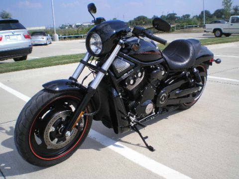2008 Harley-Davidson VROD VRSCD - A black Harley-Davidson motorcycle is parked in a lot, with a silver SUV and a white truck in the background.