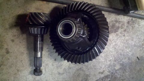 1970 Ford Bronco - A differential gear set, including a pinion gear and a ring gear, is shown on a concrete floor.