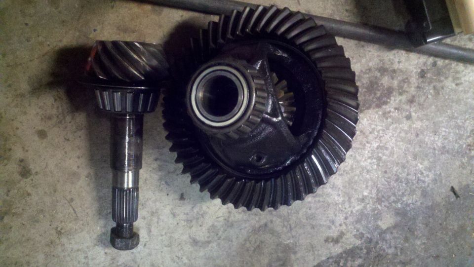 Differential gear set with pinion gear and ring gear on concrete surface