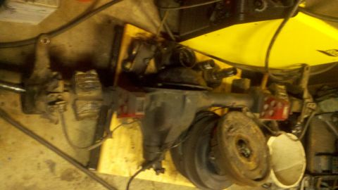 1970 Ford Bronco - Front axle assembly with brake drum and suspension components visible, likely for a vintage vehicle.