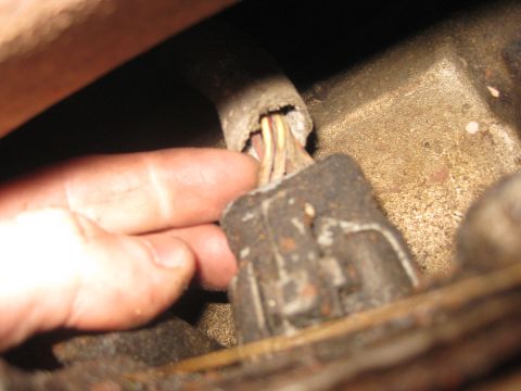 1994 Ford Bronco - Close-up of a frayed wiring harness connector, showing exposed wires.