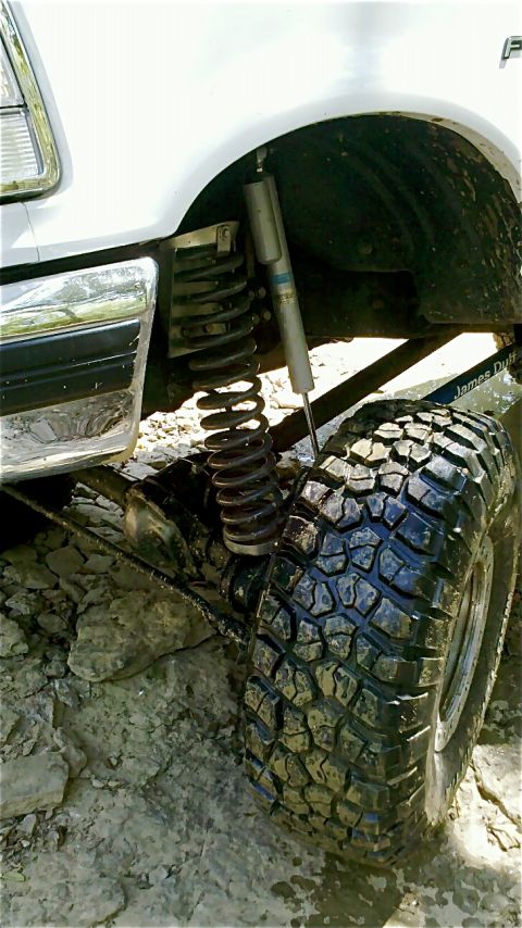 1995 Ford F-150 - The front suspension and wheel of a 1995 Ford F-150, a Bilstein shock absorber and aggressive off-road tire.