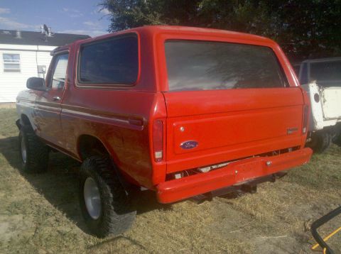 1979 Ford Bronco - This red 1979 Ford Bronco is shown from the rear quarter angle.