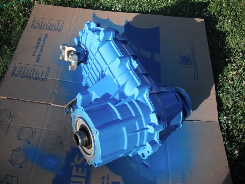 1991 Ford Bronco - A blue painted transfer case sits on cardboard in a grassy area.