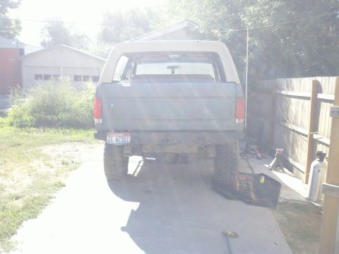1989 Ford Bronco - Rear view of a 1989 Ford Bronco with a tan removable top.