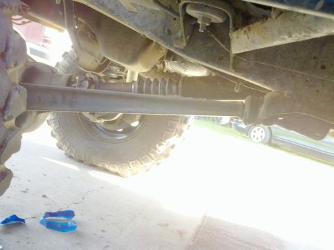 1989 Ford Bronco - Undercarriage view of a 4x4 vehicle, focusing on the suspension and drive shaft components.
