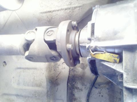 1989 Ford Bronco - Close-up view of a vehicle's driveshaft and transmission components.