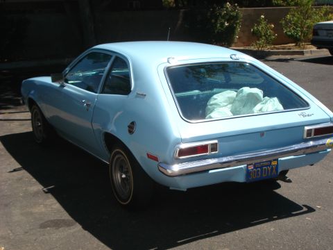1972 Ford Pinto - Rear view of a light blue 1972 Ford Pinto hatchback with items in the back seat.