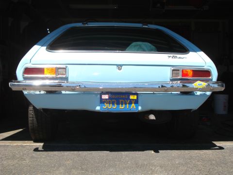 1972 Ford Pinto - The rear of a light blue 1972 Ford Pinto hatchback is shown parked in a garage.