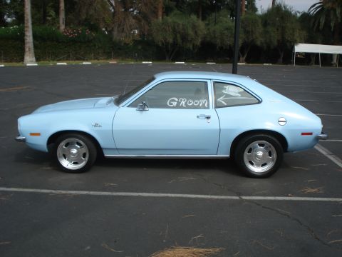 1972 Ford Pinto - A light blue 1972 Ford Pinto coupe is parked in a lot, with 'GROOM' written on the window.