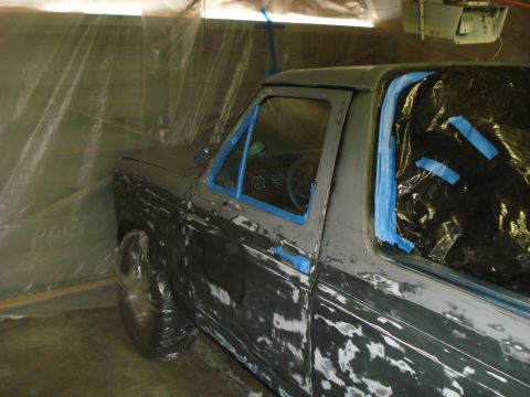 1972 Ford Pinto - A pickup truck is being prepped for paint inside a makeshift spray booth.