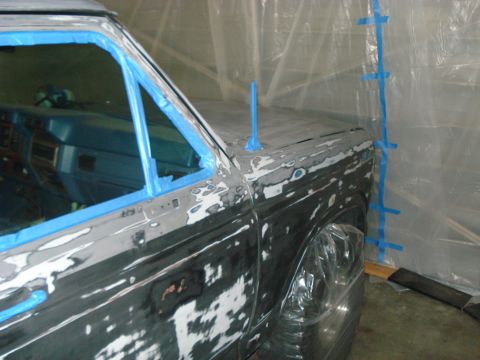 1972 Ford Pinto - Vehicle undergoing bodywork preparation, covered in primer and masking tape.