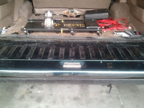 1994 Ford Bronco - The cargo area of a 1994 Ford Bronco contains a trailer dolly and jumper cables.