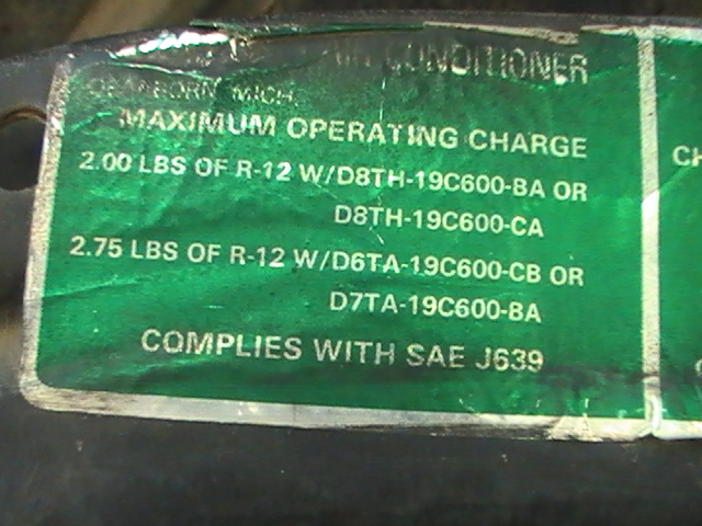Green A/C refrigerant charge label with R-12 specs and part numbers