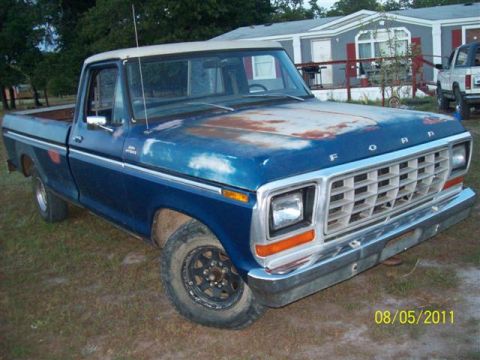 1979 Ford F-150 - This 1979 Ford F-150 pickup truck shows signs of wear and tear, with rust on the hood.