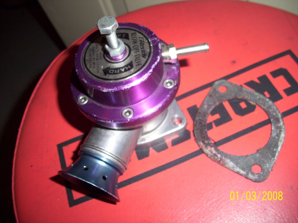 Purple blow off valve with "BLOW OFF VALVE" text and a metal gasket