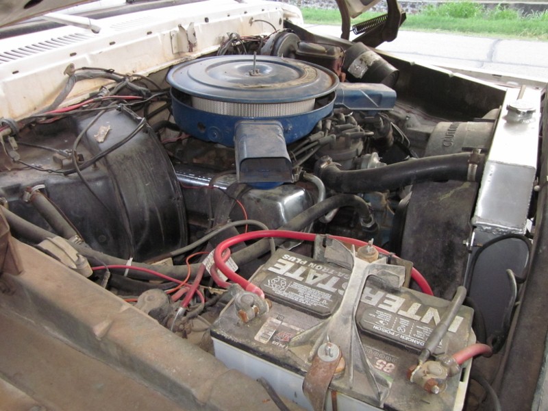 1978 Ford Bronco engine bay with blue air cleaner and dual batteries
