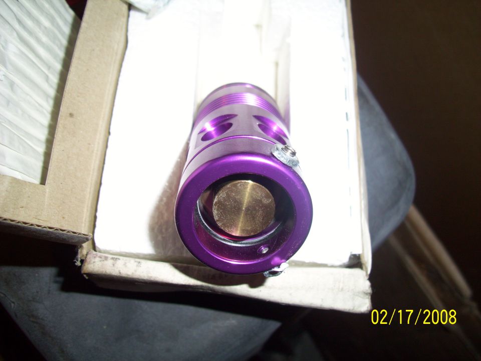 Purple anodized aluminum part with brass insert, in cardboard box