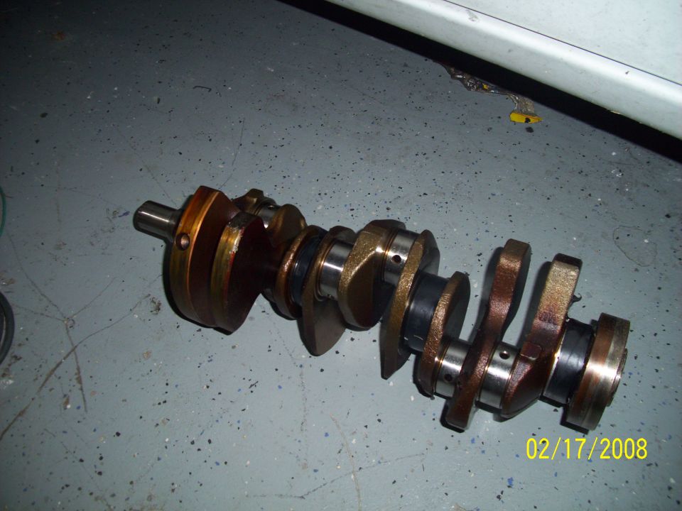Crankshaft on gray floor with date 02/17/2008 and Supermotors.net logo