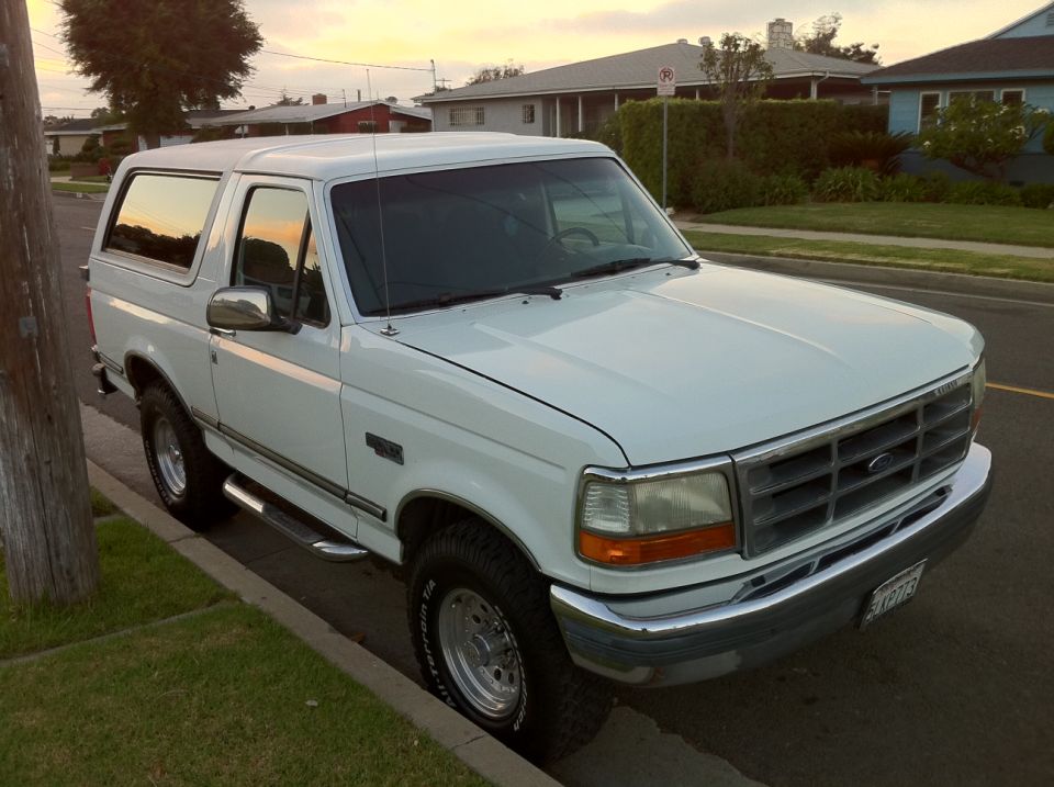 White 1992 Ford Bronco parked curbside, front quarter view