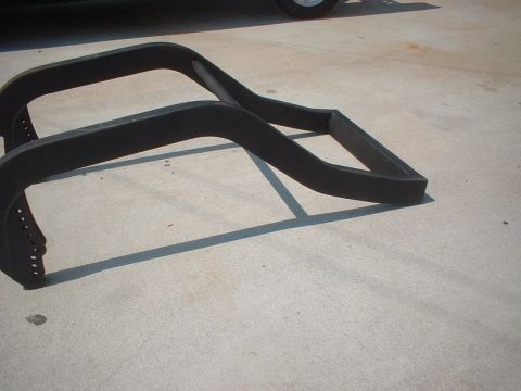 1969 Ford Torino - Two black metal frame sections are laid out on a concrete surface.