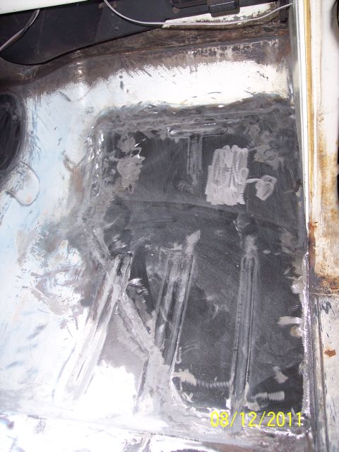 1973 Ford F-250 - The floor pan of a vehicle shows signs of rust and repair work, with a date stamp visible in the corner.