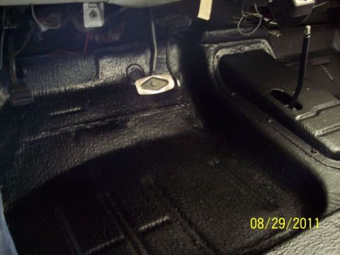 1973 Ford F-250 - The interior floor of a vehicle has been coated with a black, textured protective material.